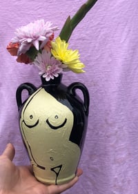 Cream figure on small black vase