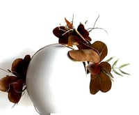 Image 3 of Tan bilateral flower headpiece. 