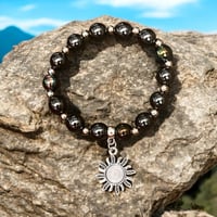hematite bracelet with opalescent sun charm