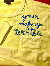 Upcycled, hand-embroidered “Your Makeup is terrible” men’s better sweater
