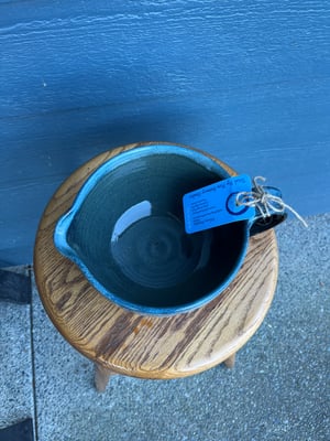 Image of Pouring Bowl, speckled black with blue rim. PB 13