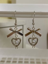 Image 2 of metal bow and heart coquette earrings