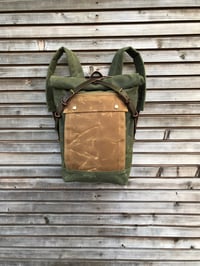 Image 2 of olive green backpack medium size rucksack in waxed canvas, with volume front pocket and double layer