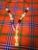 Image of Black and pink beaded necklace with gold pendant
