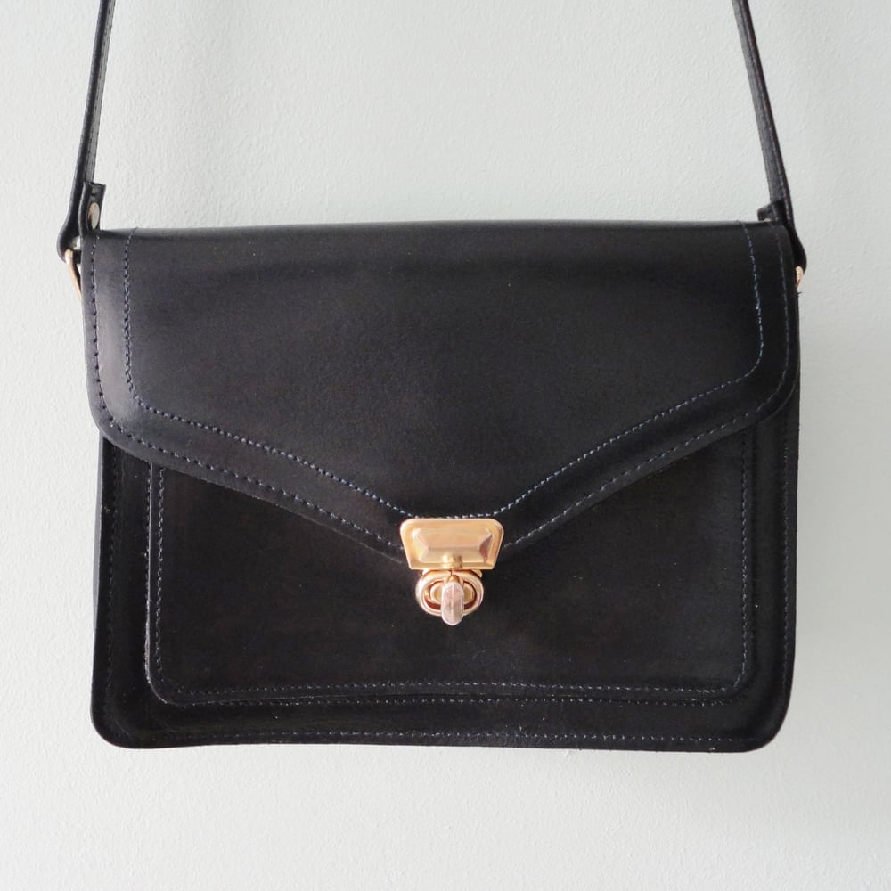 Image of Navy blue leather handbag with long strap