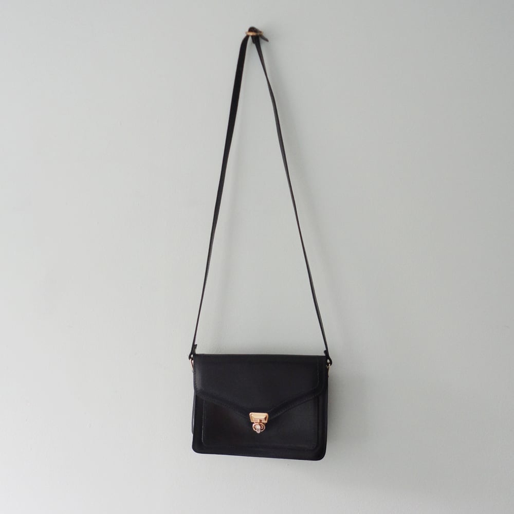 Image of Navy blue leather handbag with long strap