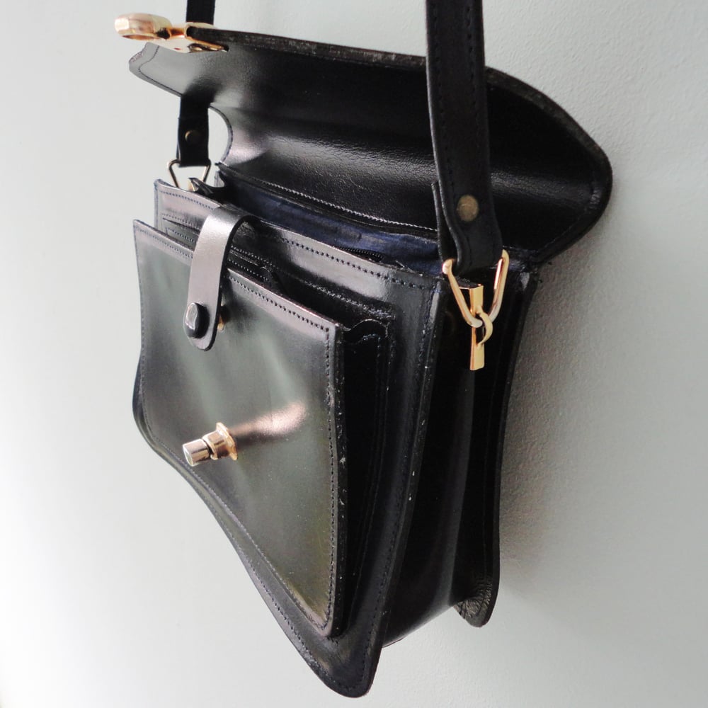 Image of Navy blue leather handbag with long strap