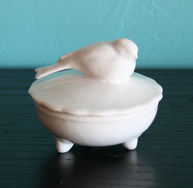 Image of small white ceramic bird on lidded trinket box