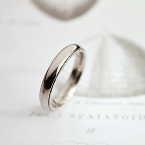 Image of 18ct white gold 4mm milled edge ring