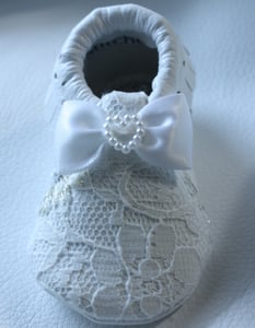 Image of white lace overlaid moccasins