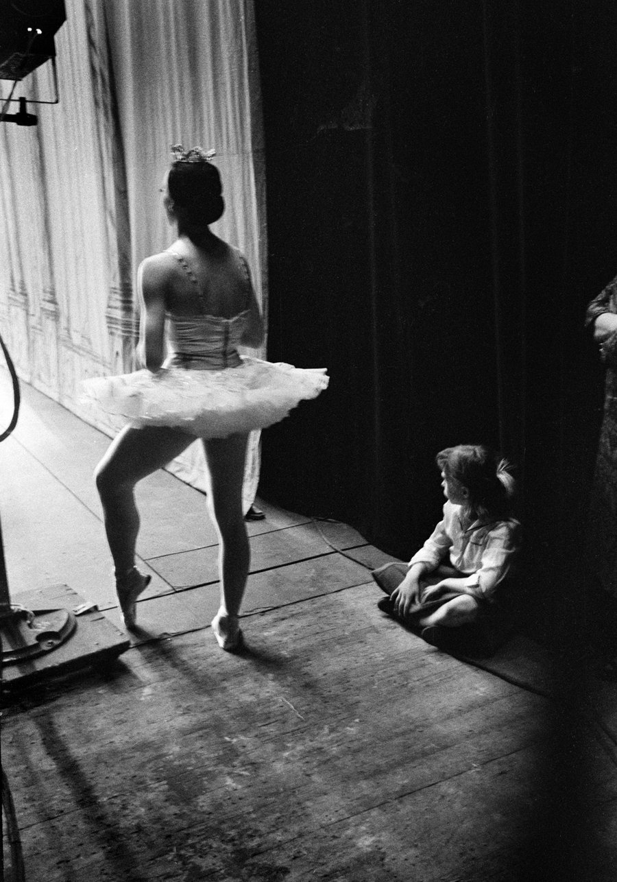 Image of Ballerina waits for her cue; a younger girl waits, too