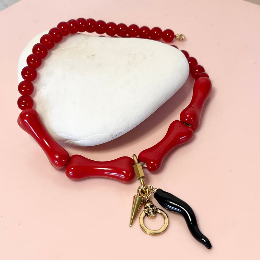 Image of Red glass bead and bone necklace with wiggly tusk