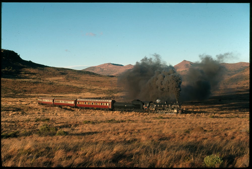 Image of A steam engine train making it’s way across the plains