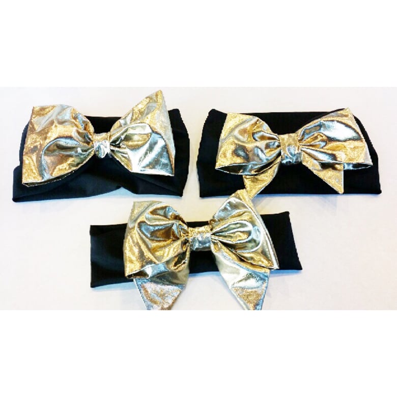 Image of Gold bow on a black headband