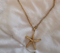 Colgante estrella marina dorada