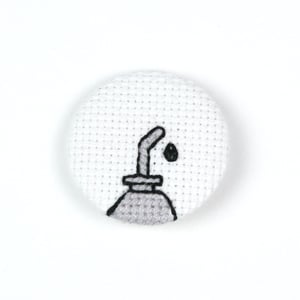 Image of Oil Can Cross-Stitched Button