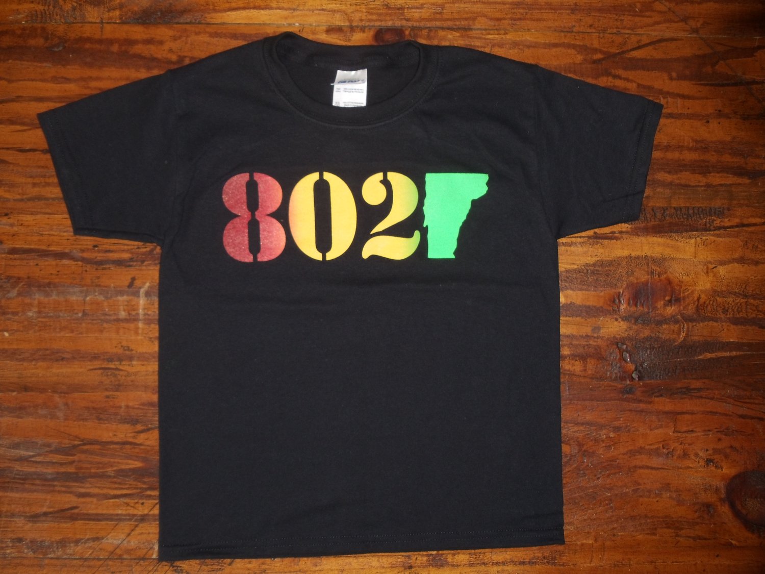 Image of 802 Classic Vermont T-Shirt - 802 on a Black Shirt - Toddler, Kids Youth & Adult (Men's & Women's)