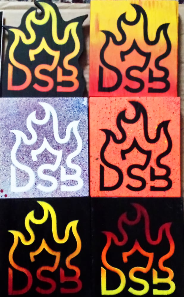 Image of DSB Products, including Wooden Flames, Sticker Packs and DSB Pendants