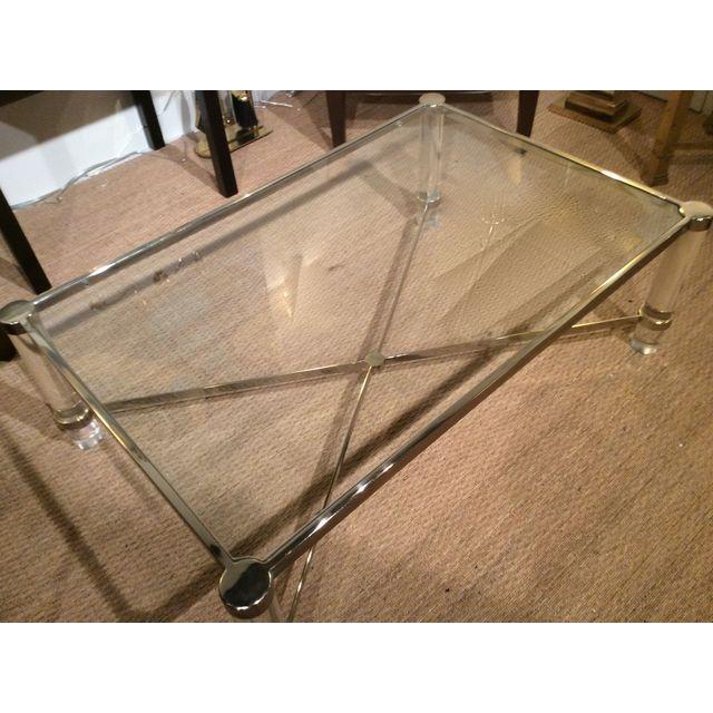 Image of Lucite and brass "X" stretcher coffee table, with glass insert top
