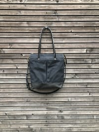 Image 2 of Black waxed canvas tote bag with leather bottom handles and cross body strap
