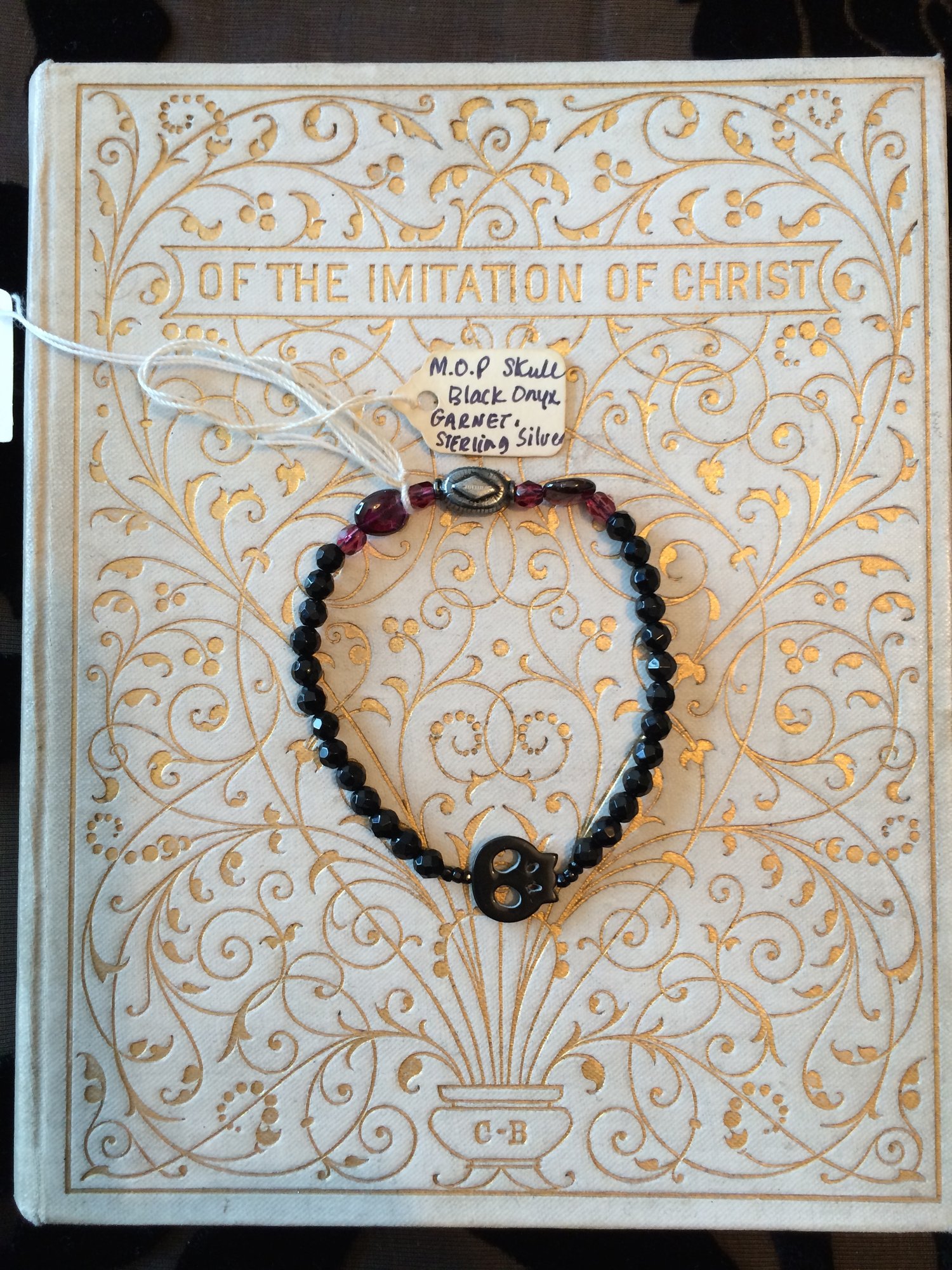 Image of Memento Mori Small Black Skull stretchy bracelet.