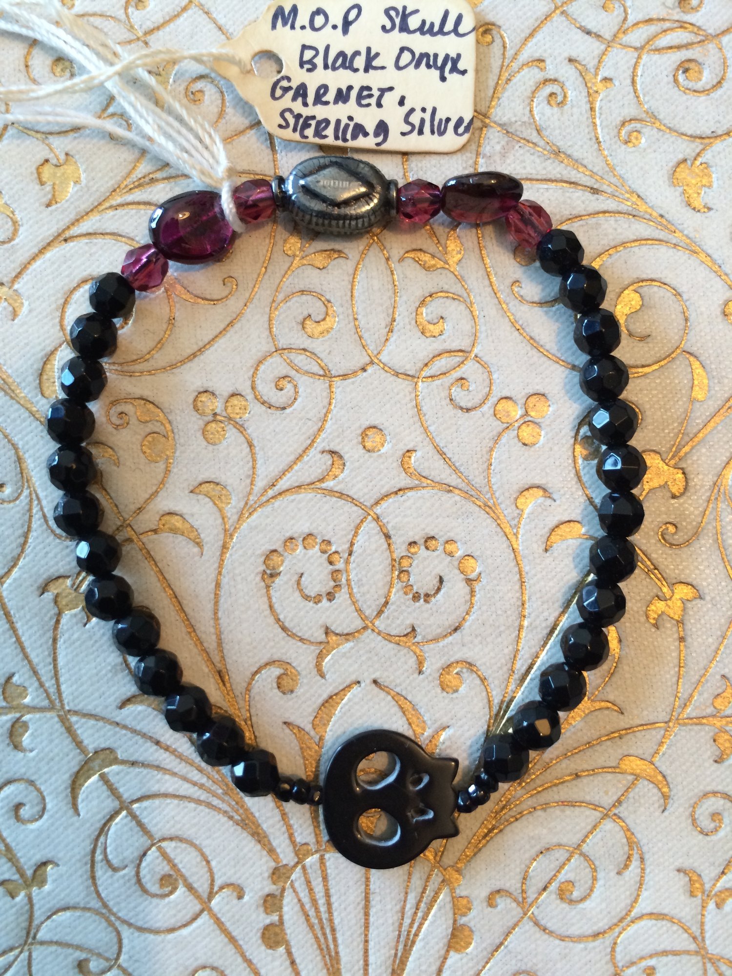 Image of Memento Mori Small Black Skull stretchy bracelet.