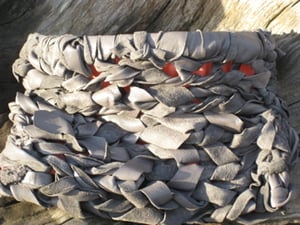 Image of hand knit leather clutch