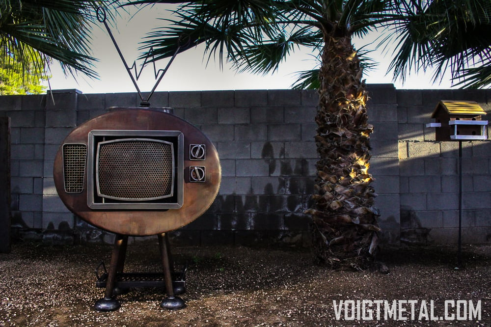 Image of "Nothings ever on" Voigt Metal T.V.-Outdoor wood burning fireplace