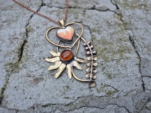 Heart pendant with orange flower