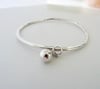 SOLID STERLING SILVER HAMMERED BANGLE WITH BALL AND KNOT