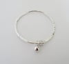 SOLID STERLING SILVER HAMMERED BANGLE WITH BALL AND KNOT