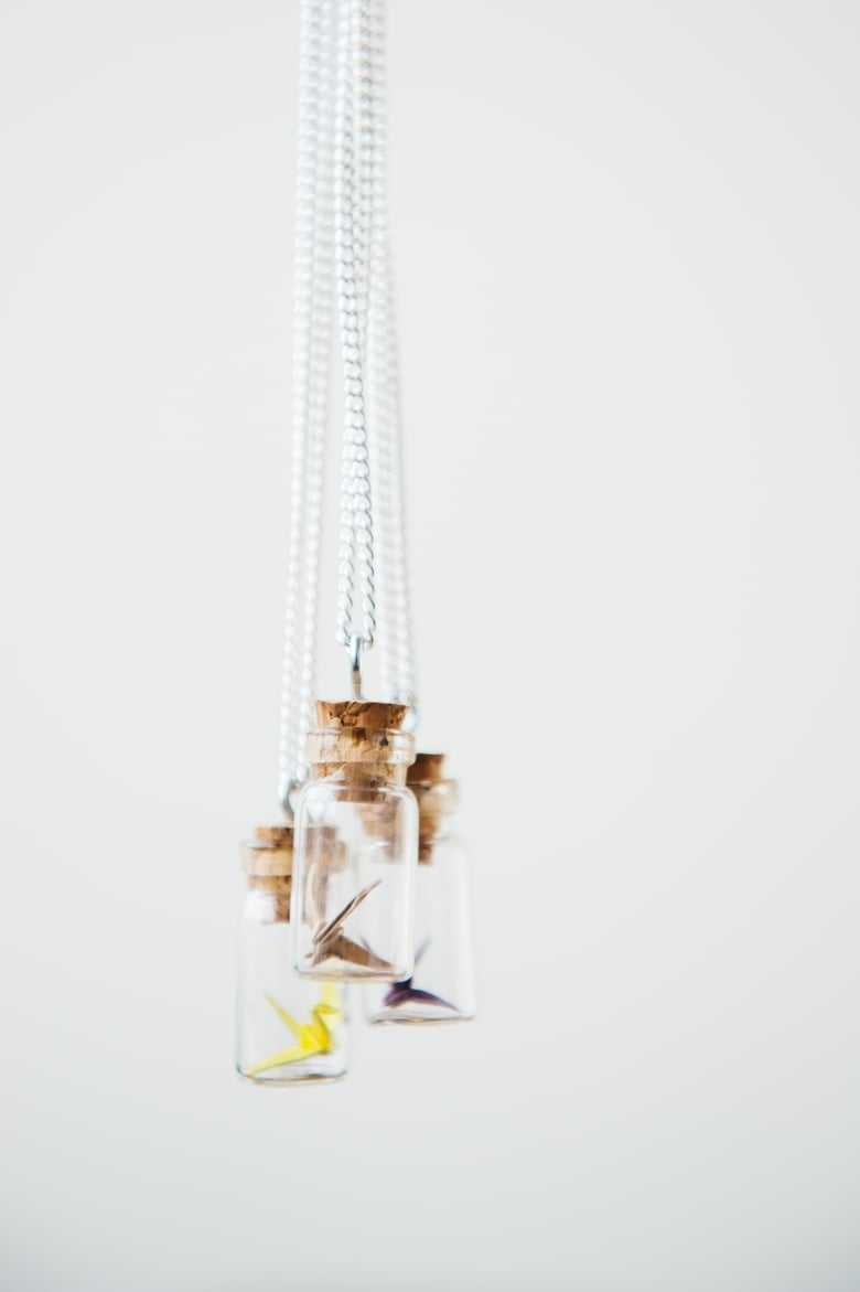 Image of Miniature origami crane in a bottle.