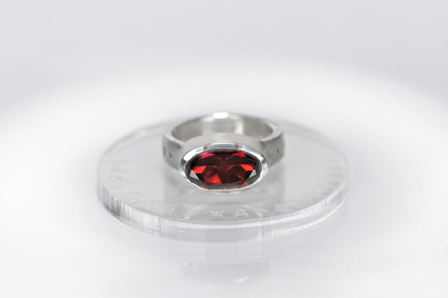 Image of "Love conquers all" silver ring with garnet  · OMNIA VINCIT AMOR ·