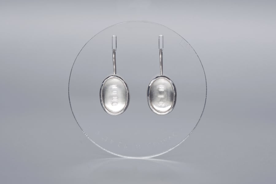 Image of silver earrings with rock crystals