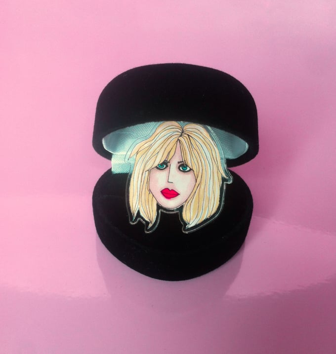 Image of Courtney Love acrylic plastic adjustable ring sold in black heart shaped box.