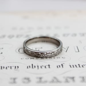 Image of Platinum 3mm flat court laurel leaf and milled edge engraved ring