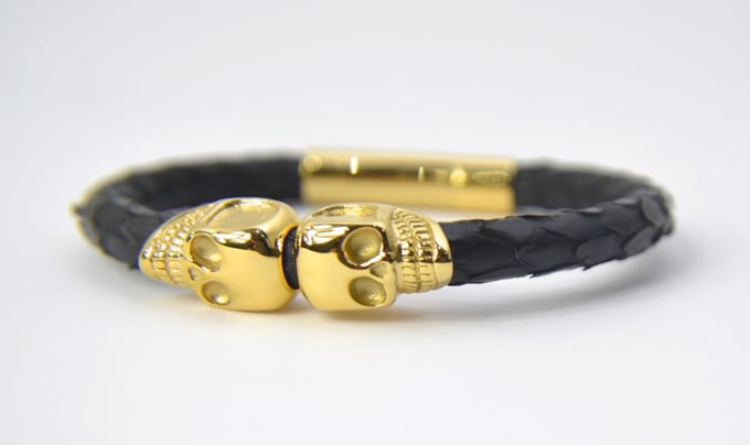 Image of 18KT. GOLD BLACK PYTHON LEATHER TWIN SKULL BRACELET