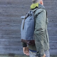 Image 1 of waxed canvas backpack with roll to close top and leather bottom