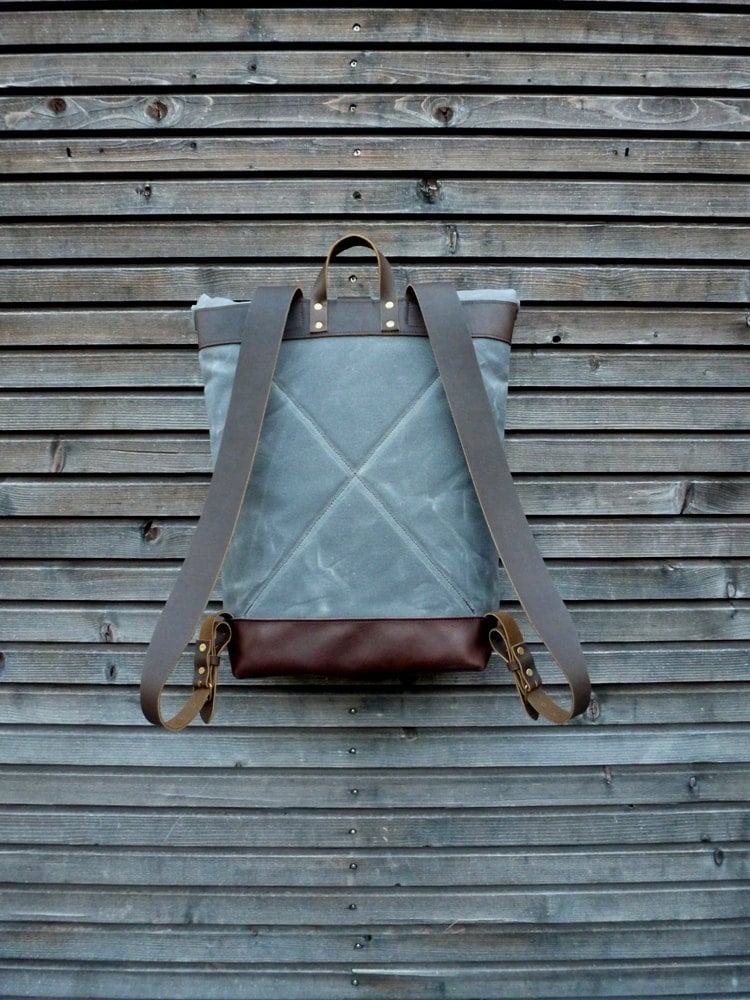 Image of waxed canvas backpack with roll to close top and leather bottom