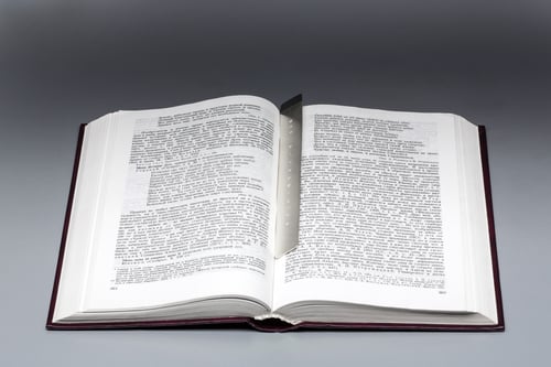 Image of silver bookmark with a Latin inscription