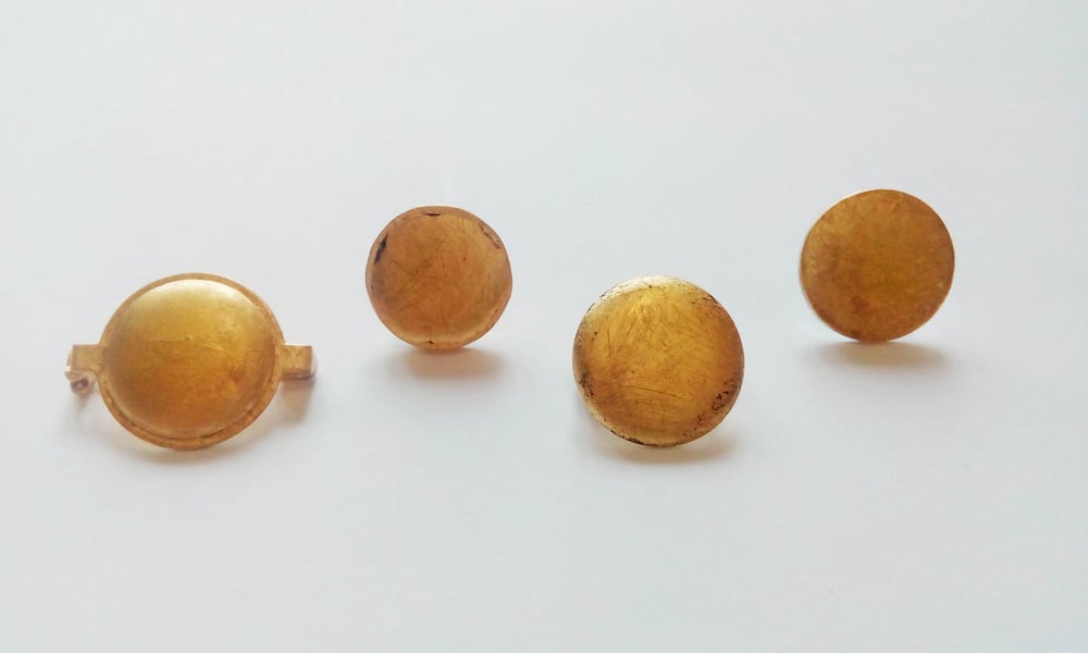 Image of Small 24ct. gold foil badges/pins.