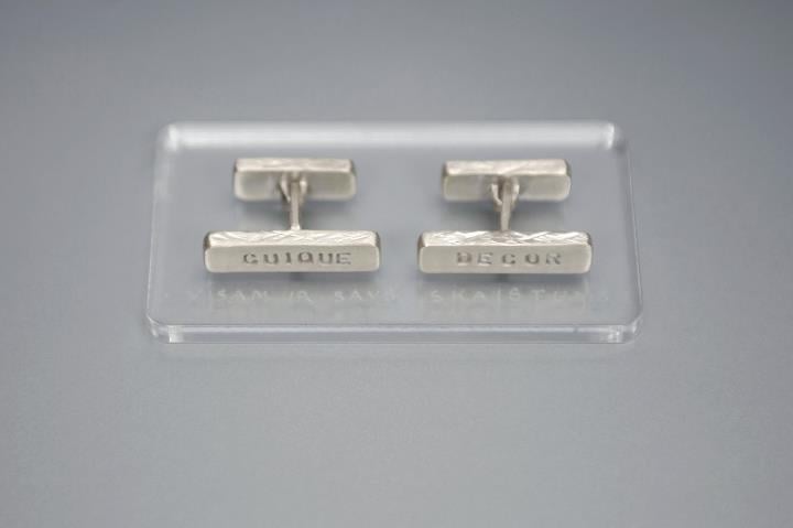 Image of silver cufflinks with inscription in Latin