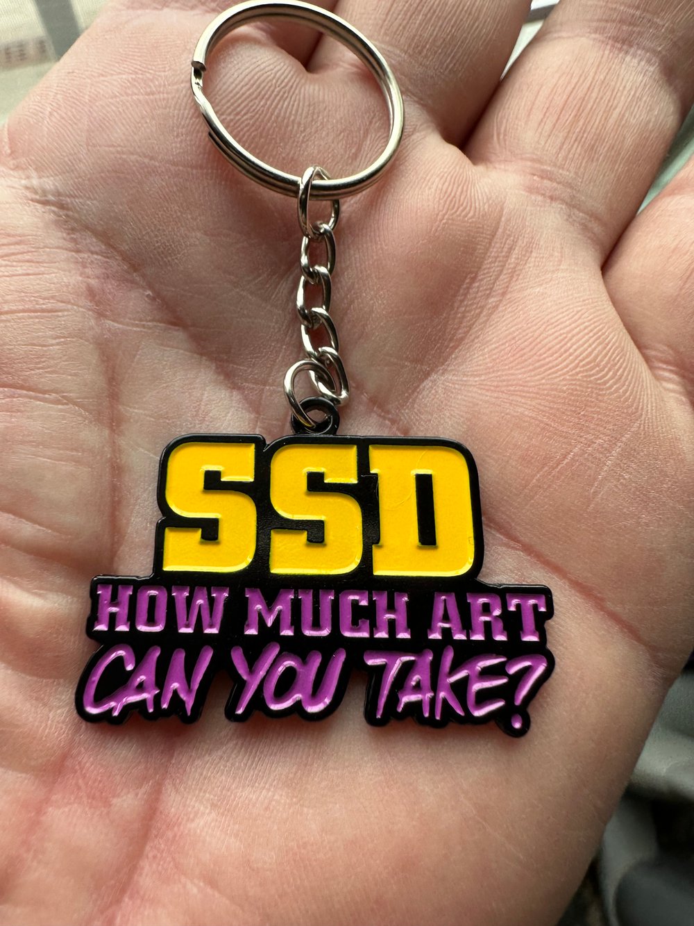 SSD “How Much Art” soft metal keychain 