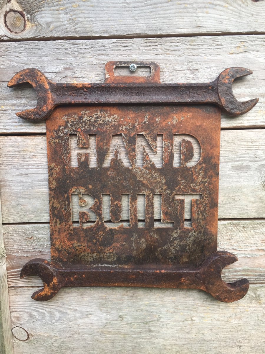 Image of 'Hand Built' rusted out wall hanging.