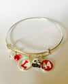 Orange Lutheran silver bangle bracelet with 3 charms and beads