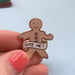 Image of 'Bite Me' Gingerbread Man Enamel Pin