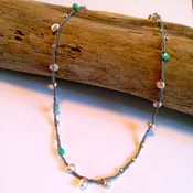 Image of pink pearls, turquoise, and silver beads crocheted on silk