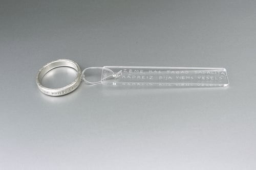 Image of silver thin ring with inscription in Latin