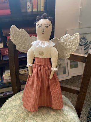 Image of A folk art angel in striped skirt