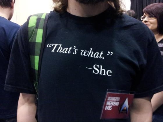 Image of The original "That's what."—She men's tee and ladies' black tank